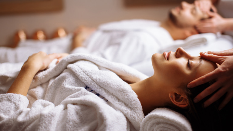 Happy Young Beautiful Couple Enjoying Head Massage Spa (1)